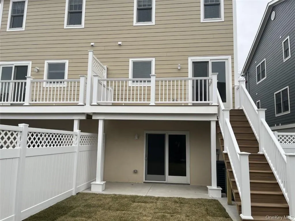 Rear view of property featuring a patio area and stairs Rear view of property featuring a patio area and stairs