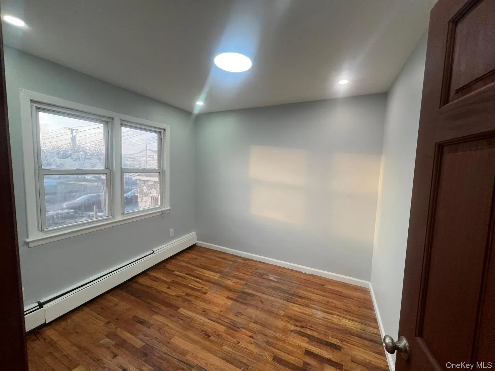 Spare room featuring a baseboard heating unit, dark wood finished floors, and recessed lighting Spare room featuring a baseboard heating unit, dark wood finished floors, and recessed lighting