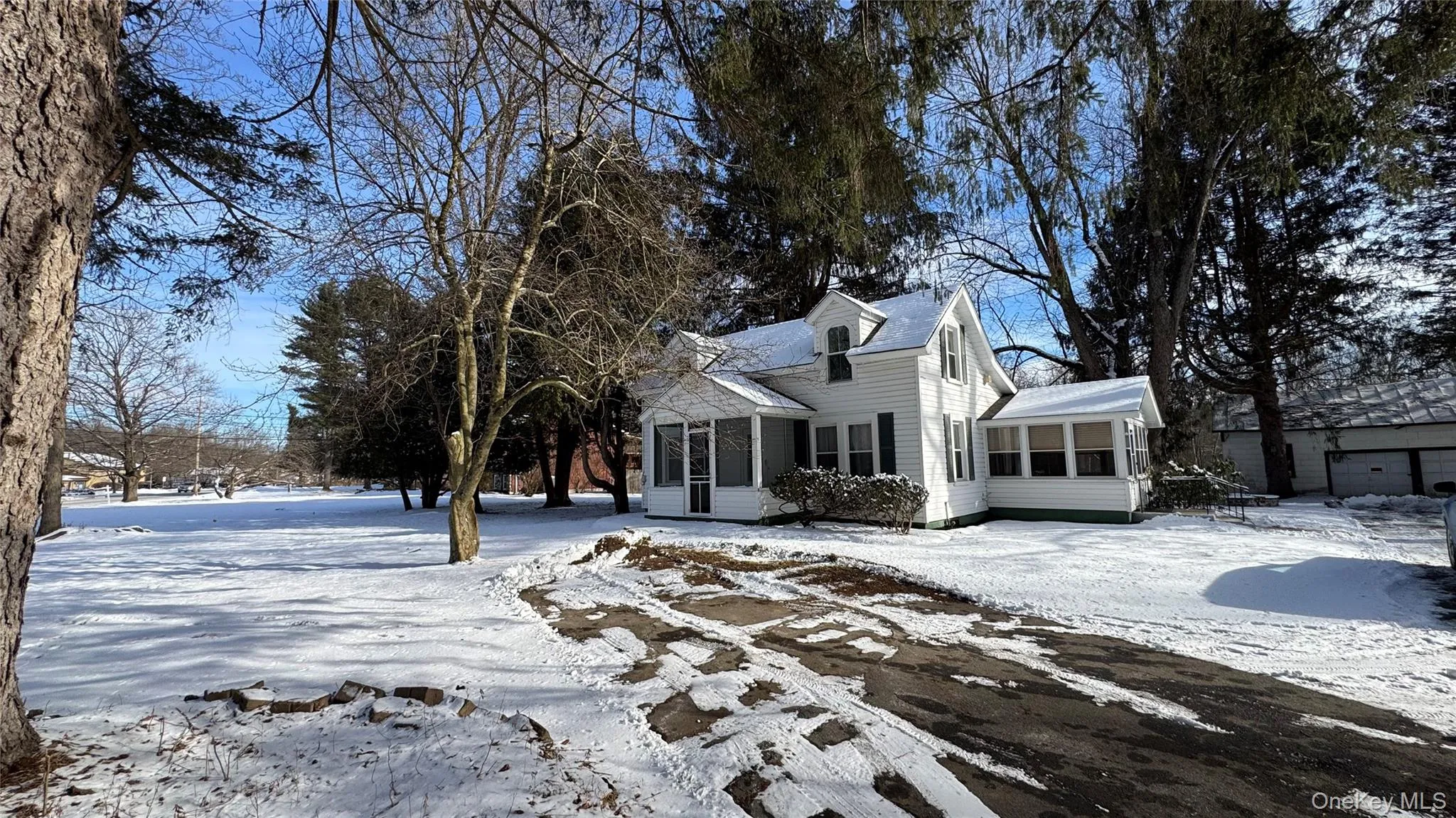 View of front of property featuring a sunroom View of front of property featuring a sunroom