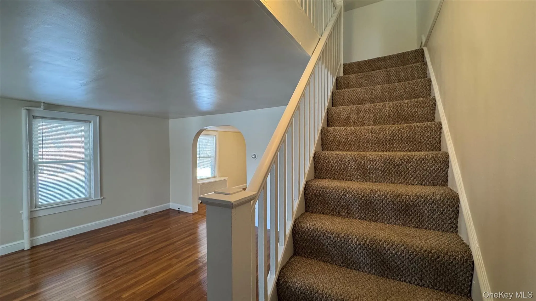 Stairs with arched walkways and wood finished floors Stairs with arched walkways and wood finished floors