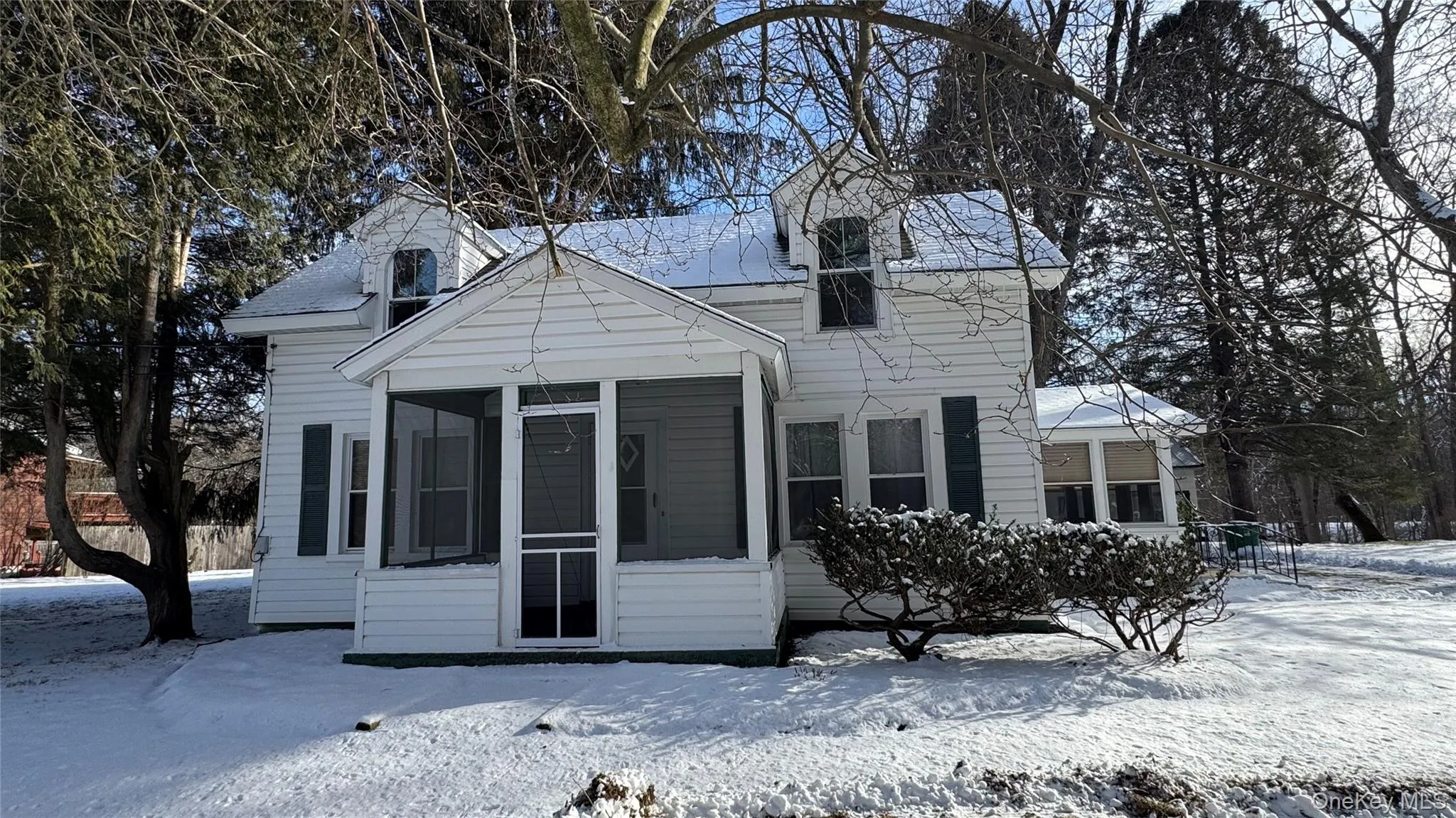 View of front of house featuring a sunroom View of front of house featuring a sunroom
