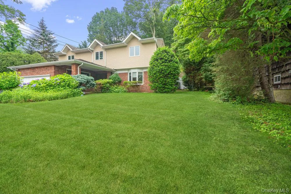 View of front of house with brick siding and a front lawn View of front of house with brick siding and a front lawn
