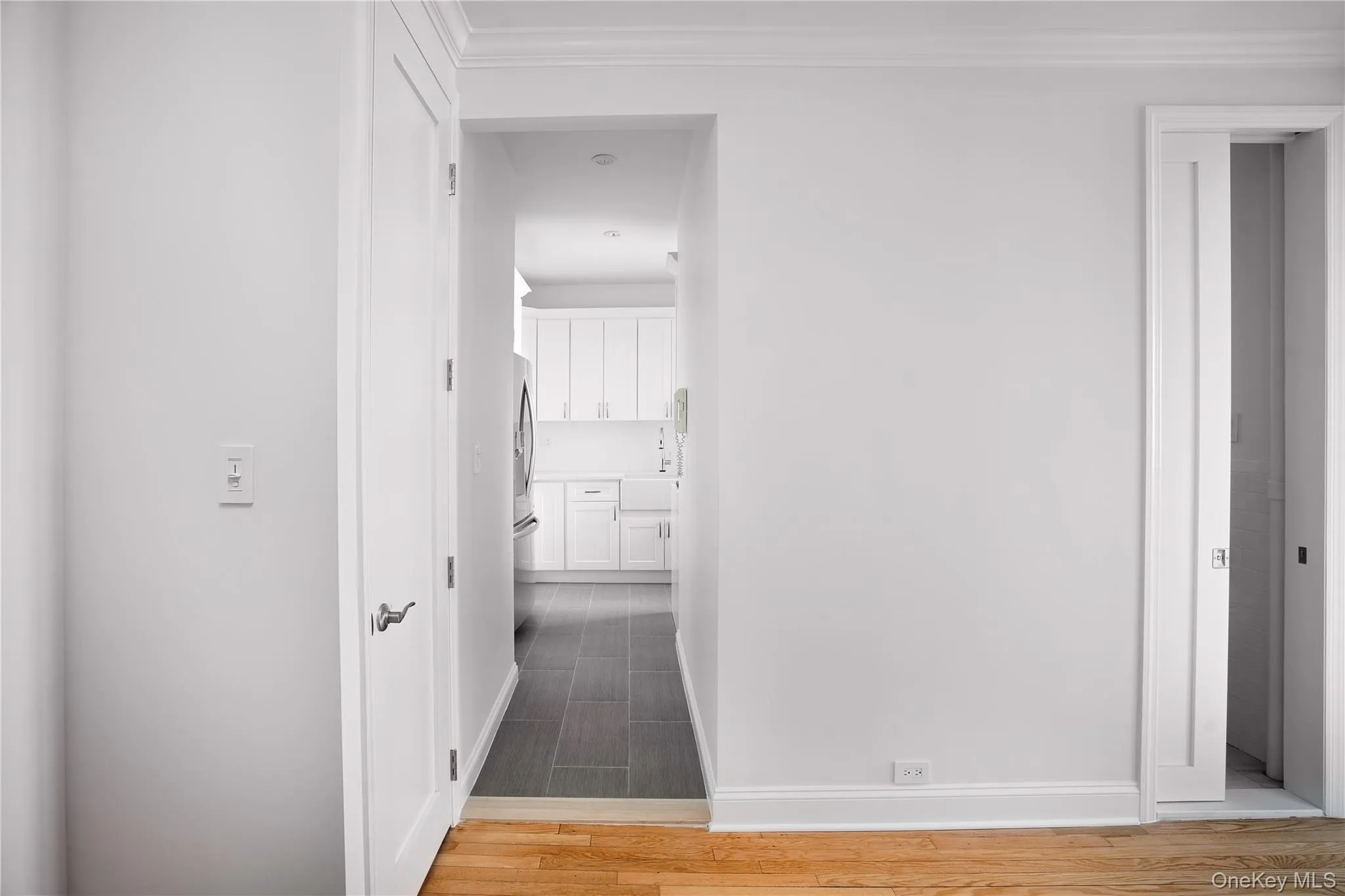Hallway with wood tiled floors, crown molding, and elevator Hallway with wood tiled floors, crown molding, and elevator