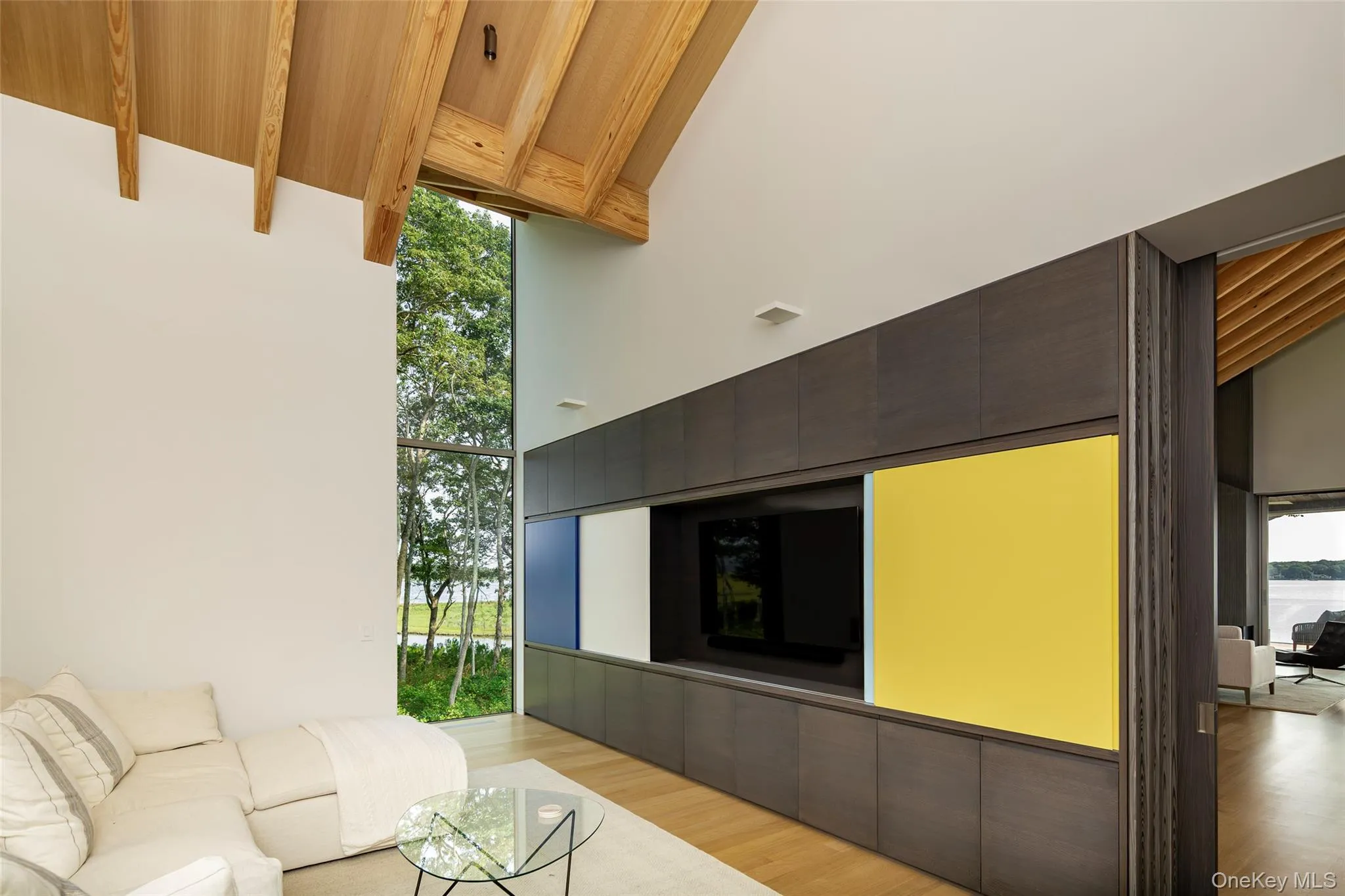 Living room featuring light wood-style flooring, high vaulted ceiling, and a wooden ceiling with exposed beams Living room featuring light wood-style flooring, high vaulted ceiling, and a wooden ceiling with exposed beams