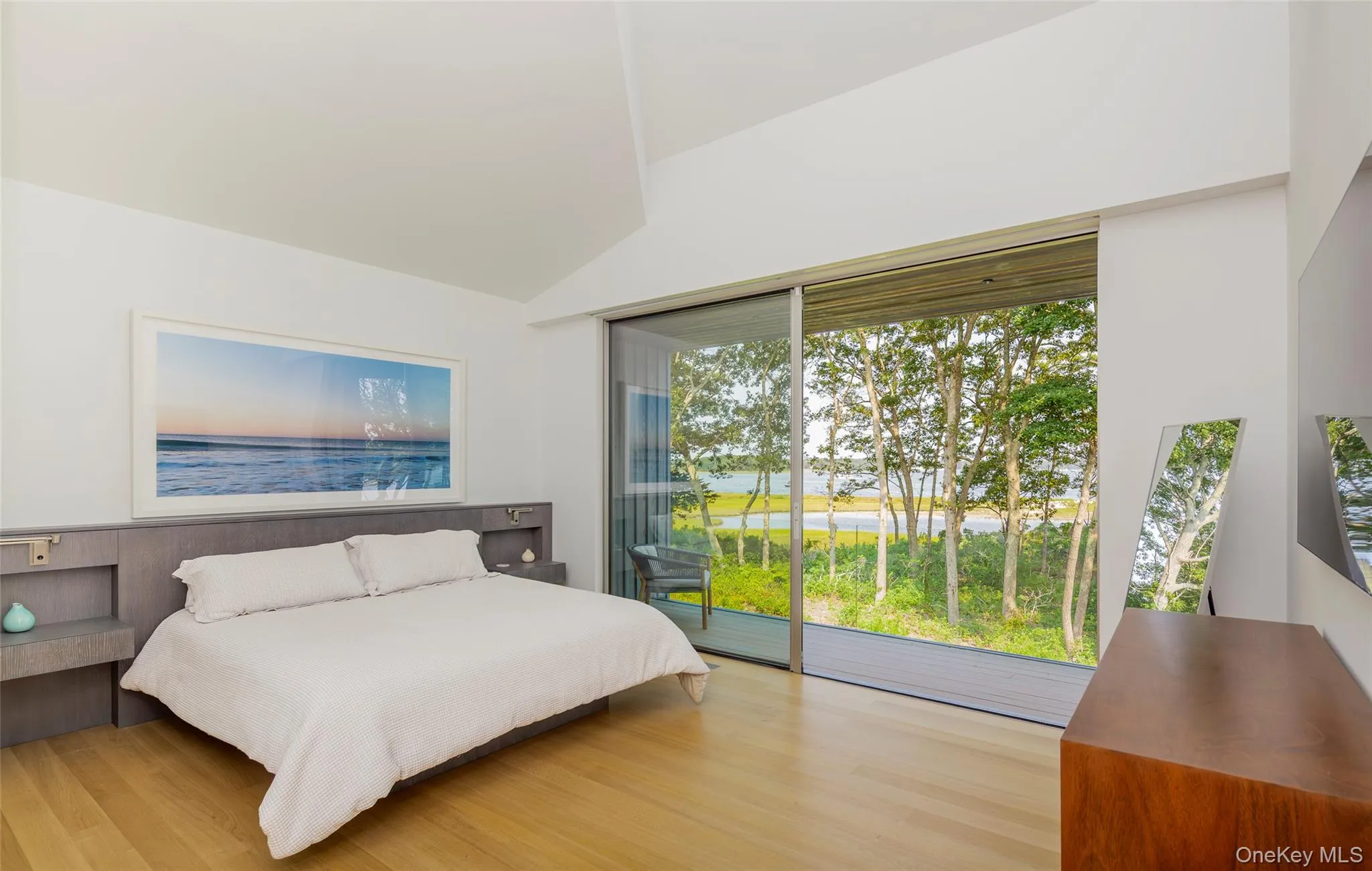 Bedroom with access to exterior, light wood-type flooring, and vaulted ceiling Bedroom with access to exterior, light wood-type flooring, and vaulted ceiling