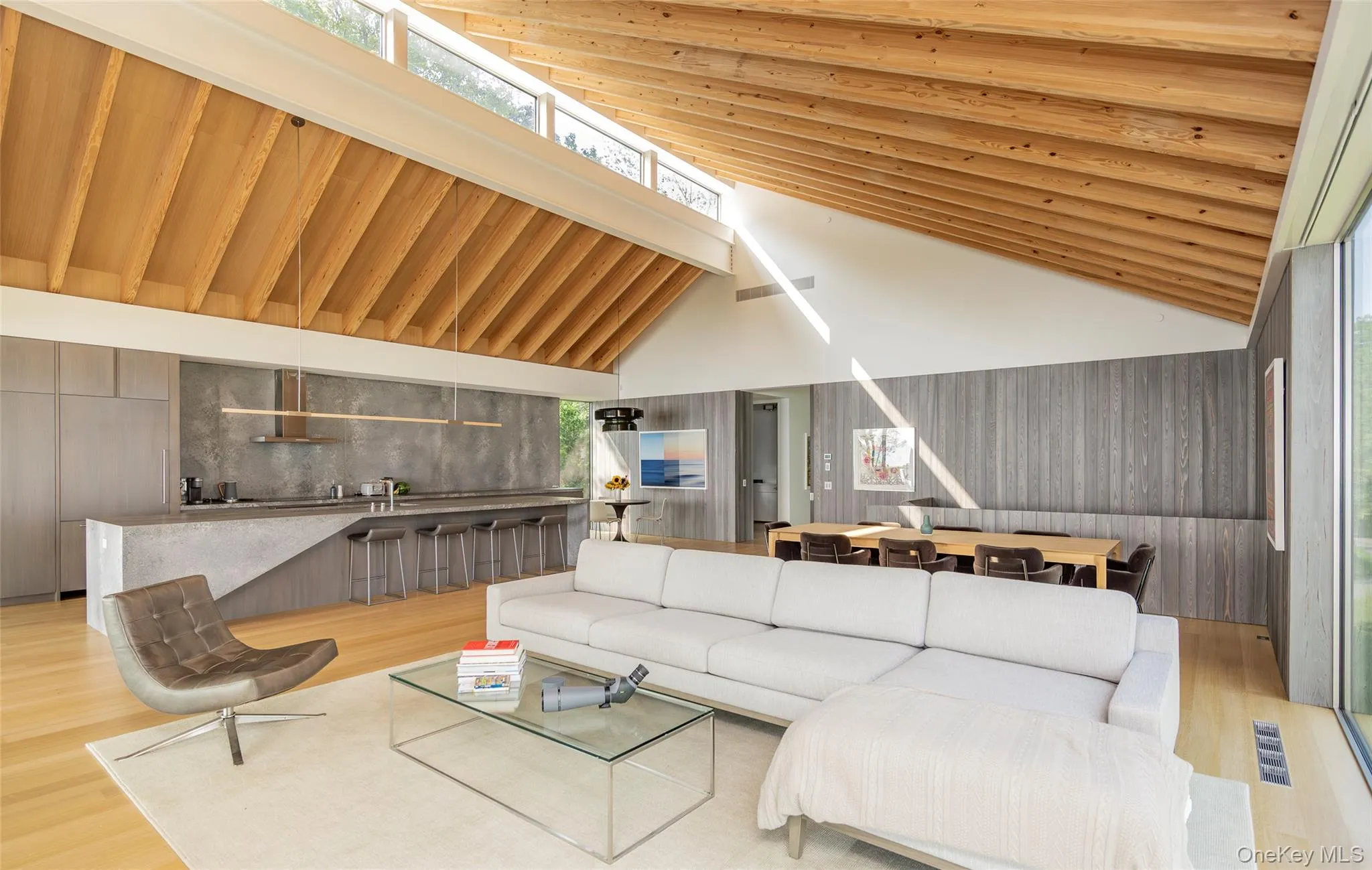 Living room with wood finished floors and high vaulted ceiling Living room with wood finished floors and high vaulted ceiling