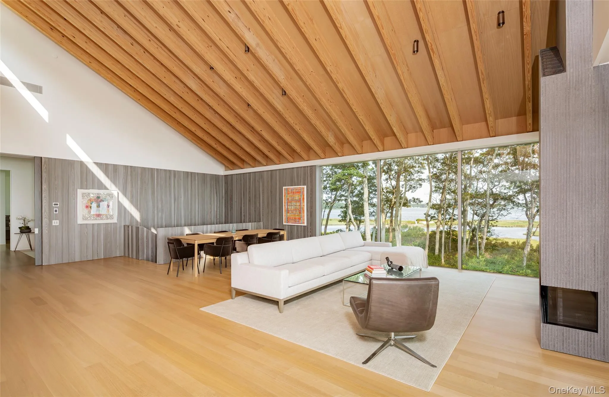 Living room featuring light wood-style flooring, high vaulted ceiling, wooden ceiling, and a water view Living room featuring light wood-style flooring, high vaulted ceiling, wooden ceiling, and a water view