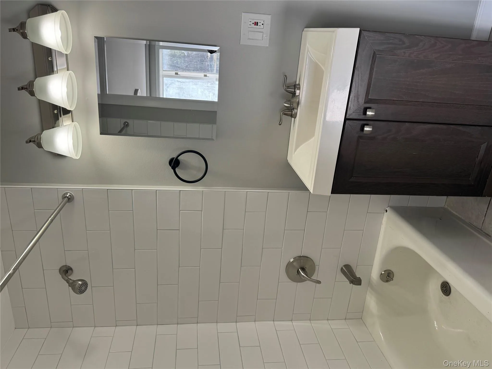 Bathroom featuring vanity and tiled shower / bath Bathroom featuring vanity and tiled shower / bath