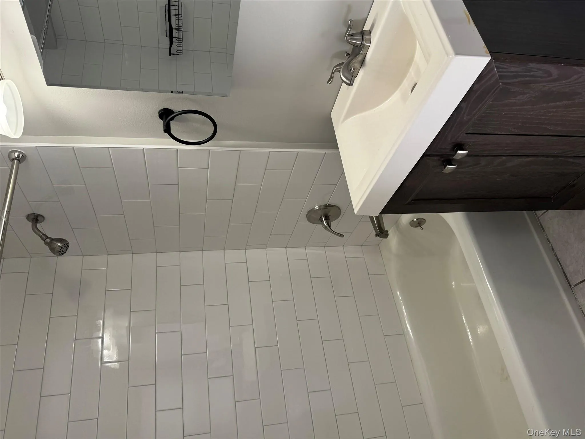 Bathroom with tile patterned floors, vanity, and tiled shower / bath Bathroom with tile patterned floors, vanity, and tiled shower / bath