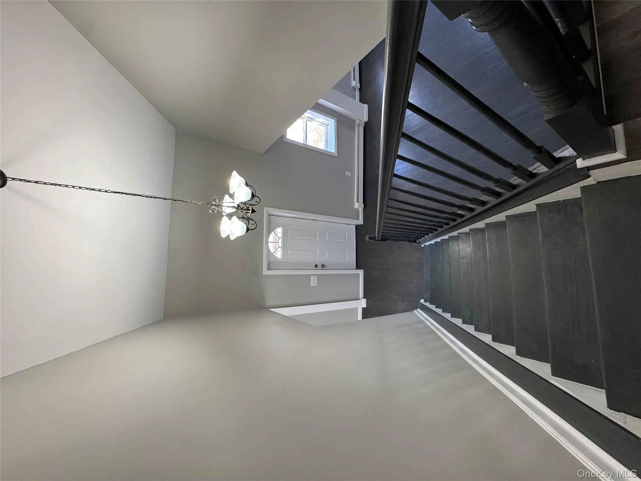 Stairs with hardwood / wood-style flooring and an inviting chandelier Stairs with hardwood / wood-style flooring and an inviting chandelier