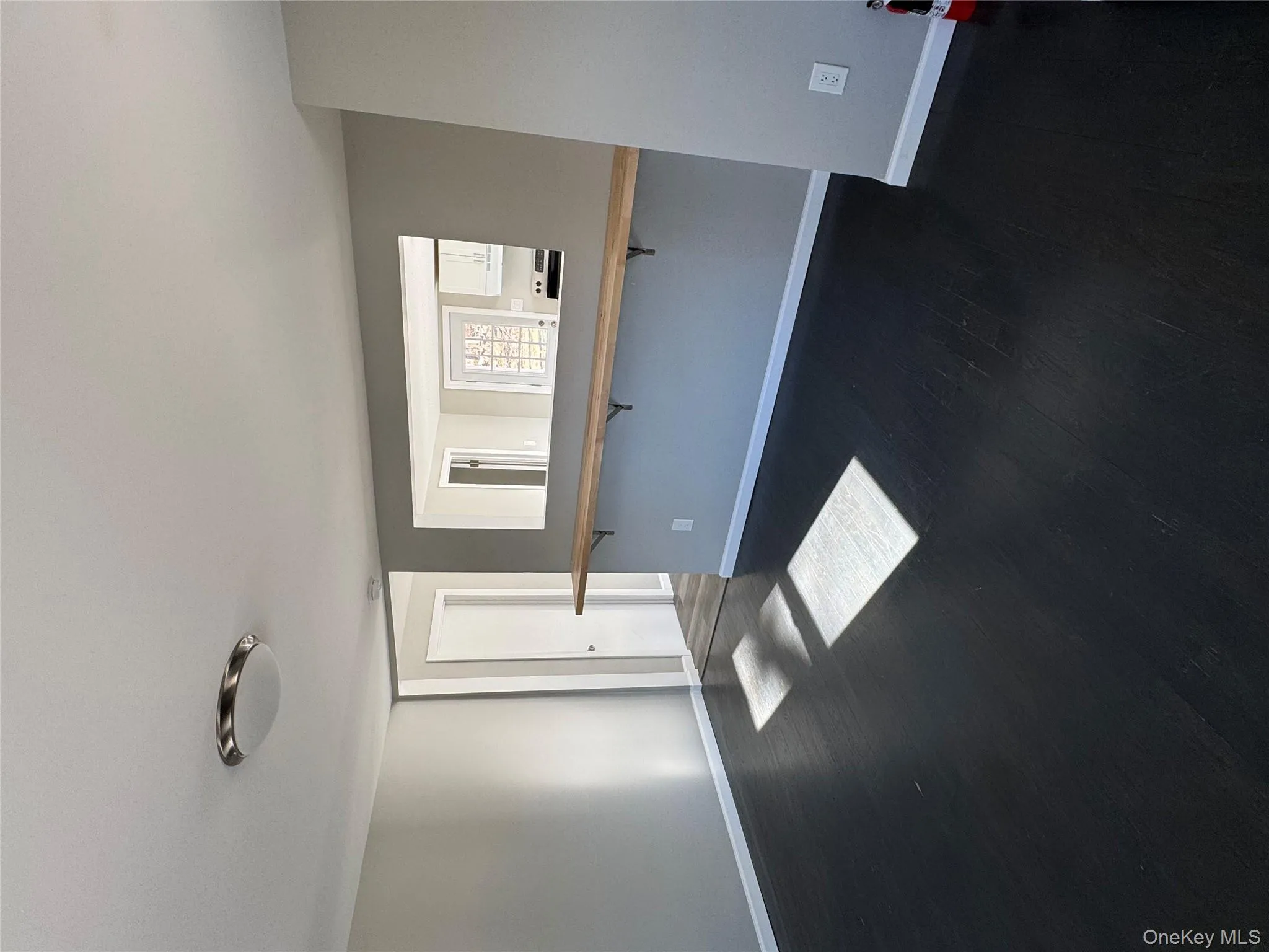 Unfurnished room with dark hardwood / wood-style floors Unfurnished room with dark hardwood / wood-style floors