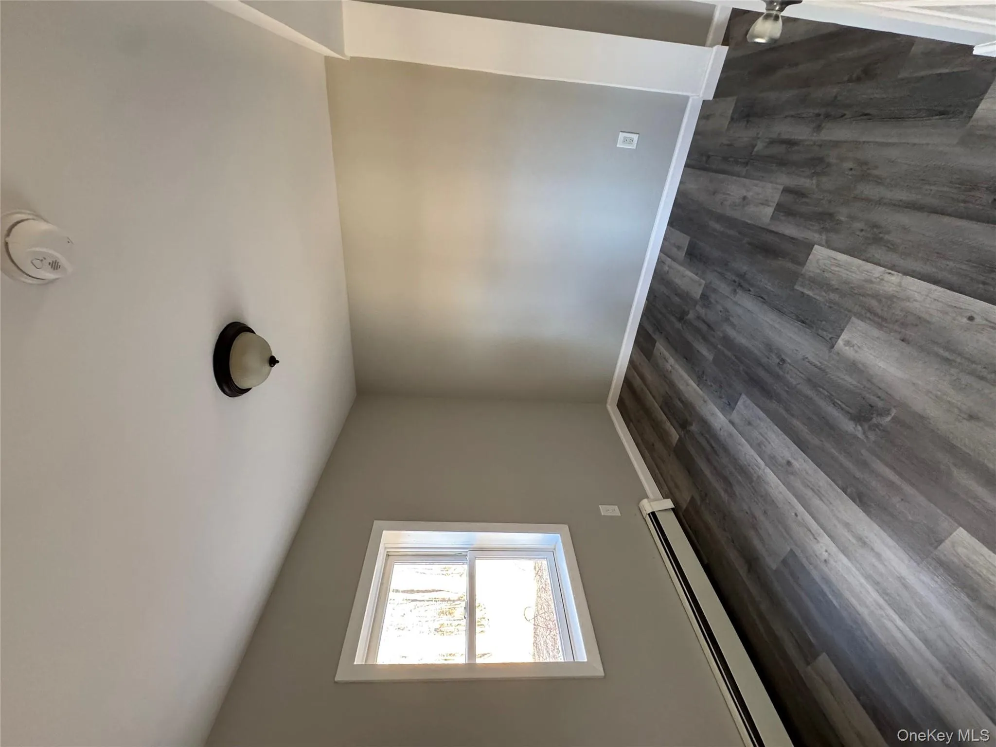 Unfurnished room featuring dark hardwood / wood-style floors and a baseboard heating unit Unfurnished room featuring dark hardwood / wood-style floors and a baseboard heating unit