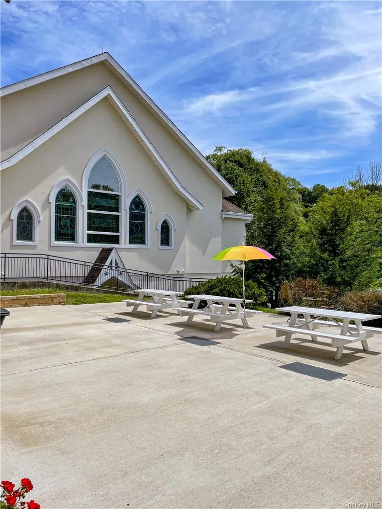 The area behind the building has outdoor patio furniture for the tenants enjoyment. The area behind the building has outdoor patio furniture for the tenants enjoyment.