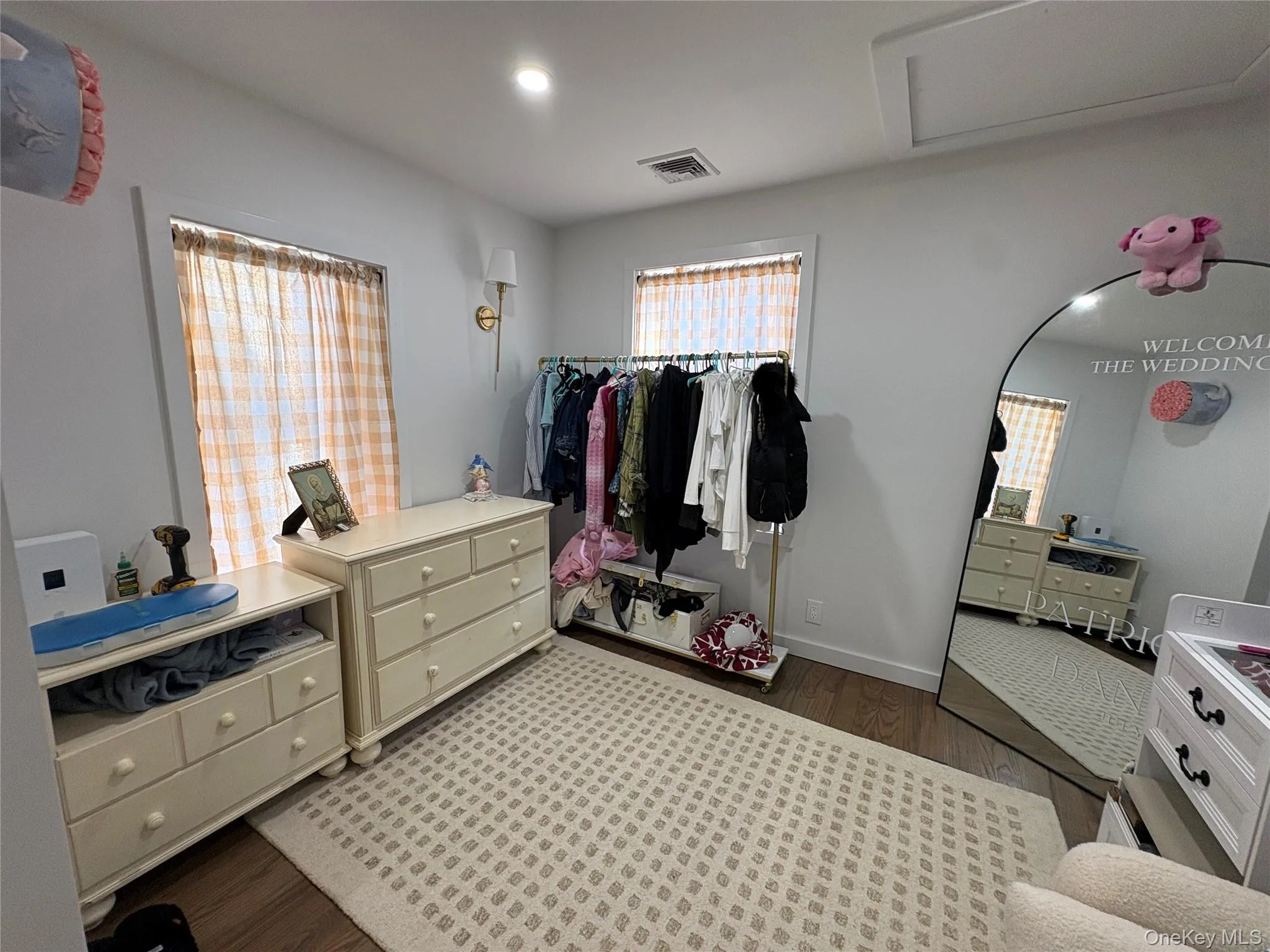 Bedroom featuring dark wood finished floors and attic access Bedroom featuring dark wood finished floors and attic access