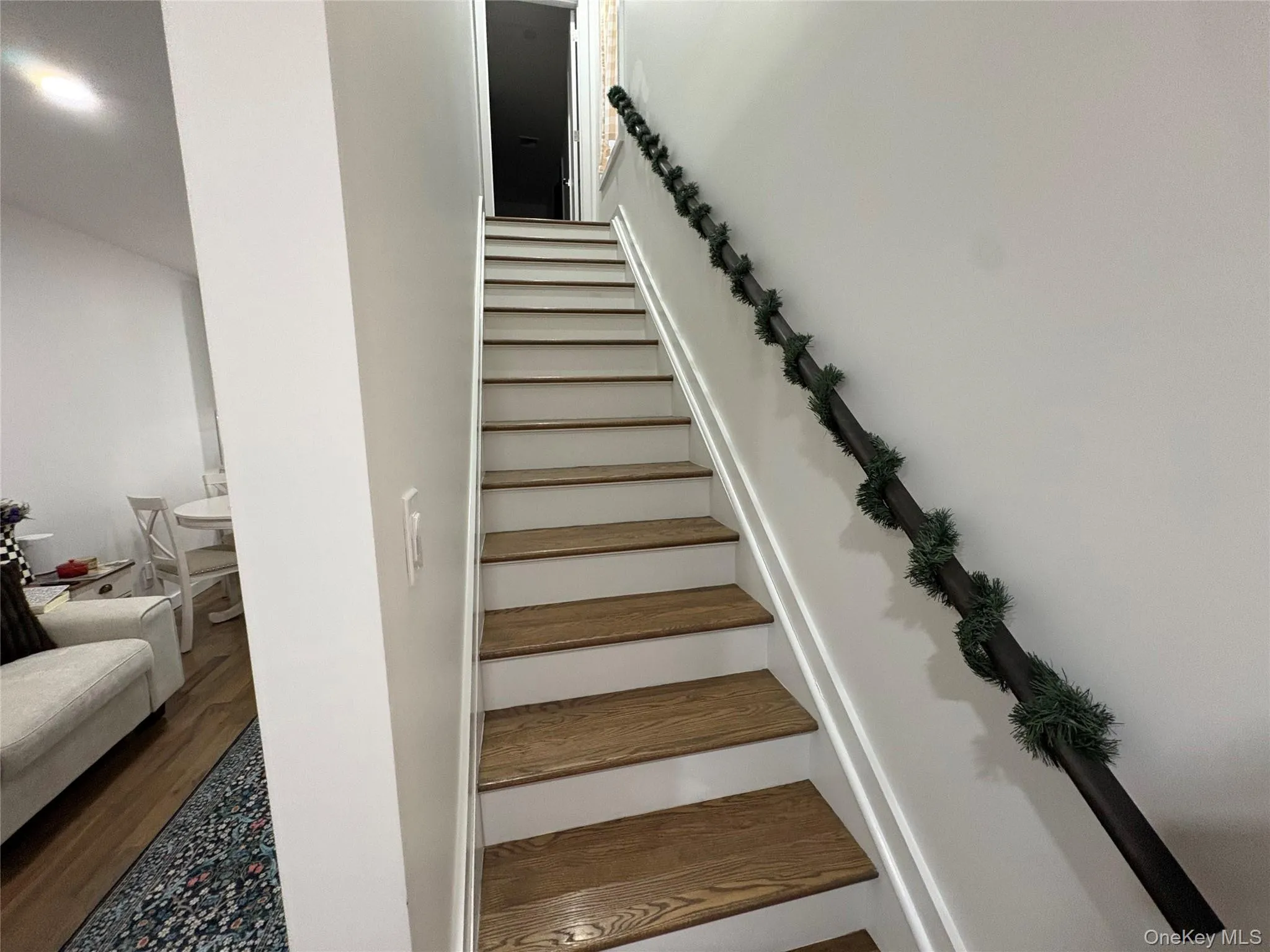 Stairway featuring wood finished floors Stairway featuring wood finished floors