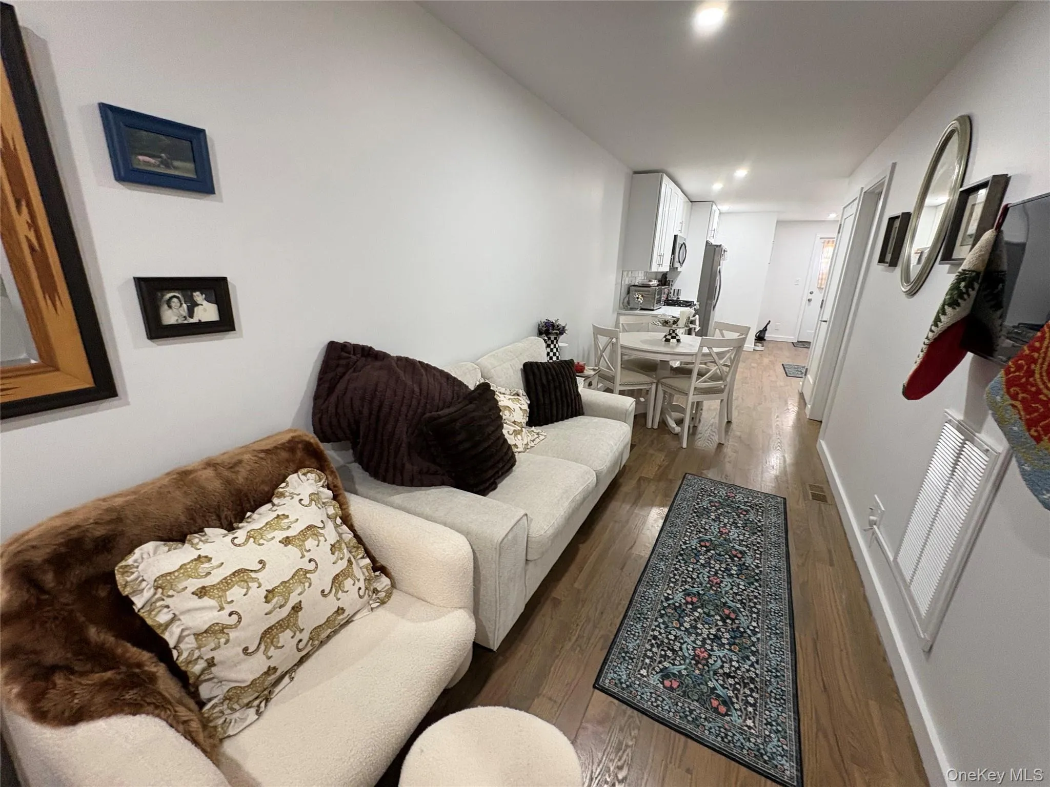 Living room featuring wood-type flooring and recessed lighting Living room featuring wood-type flooring and recessed lighting