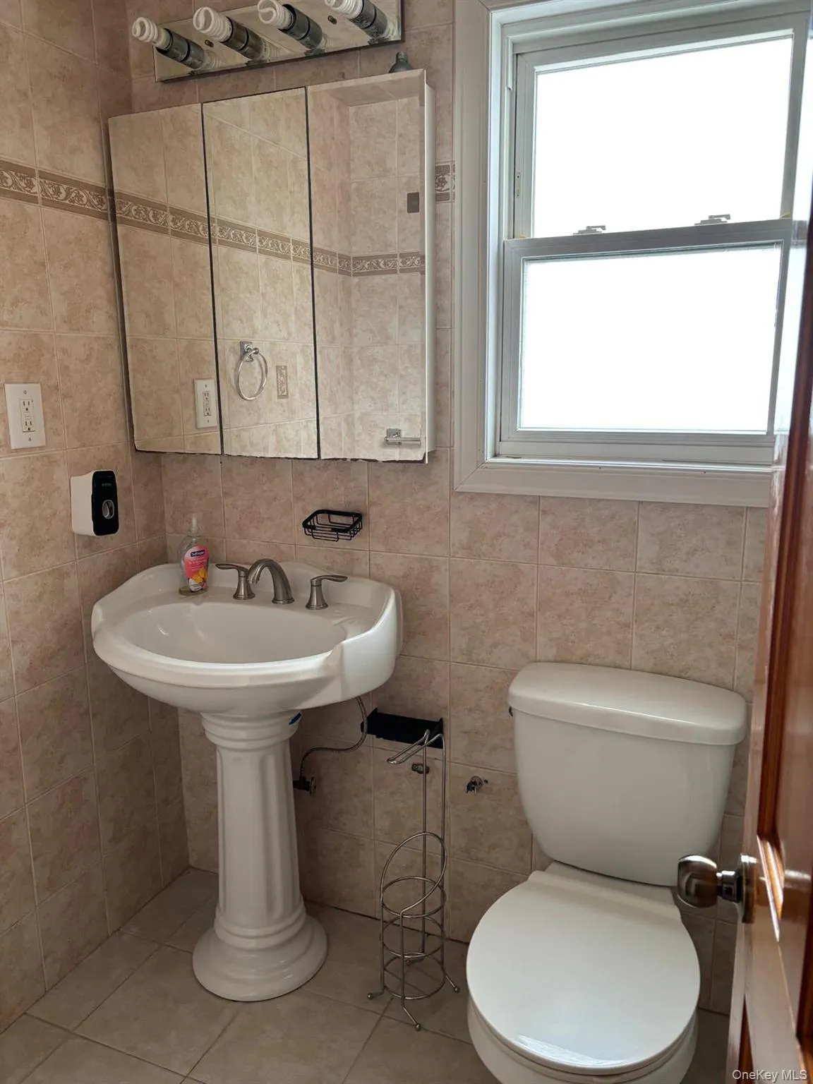 Bathroom with tile patterned floors and tile walls Bathroom with tile patterned floors and tile walls