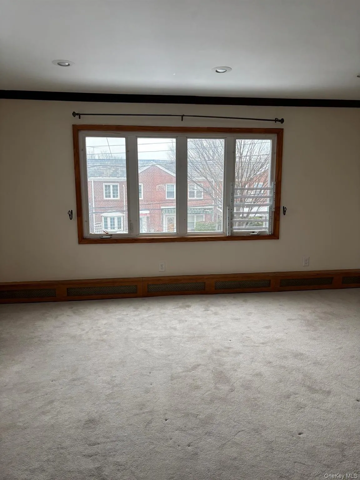 Carpeted spare room featuring crown molding and recessed lighting Carpeted spare room featuring crown molding and recessed lighting