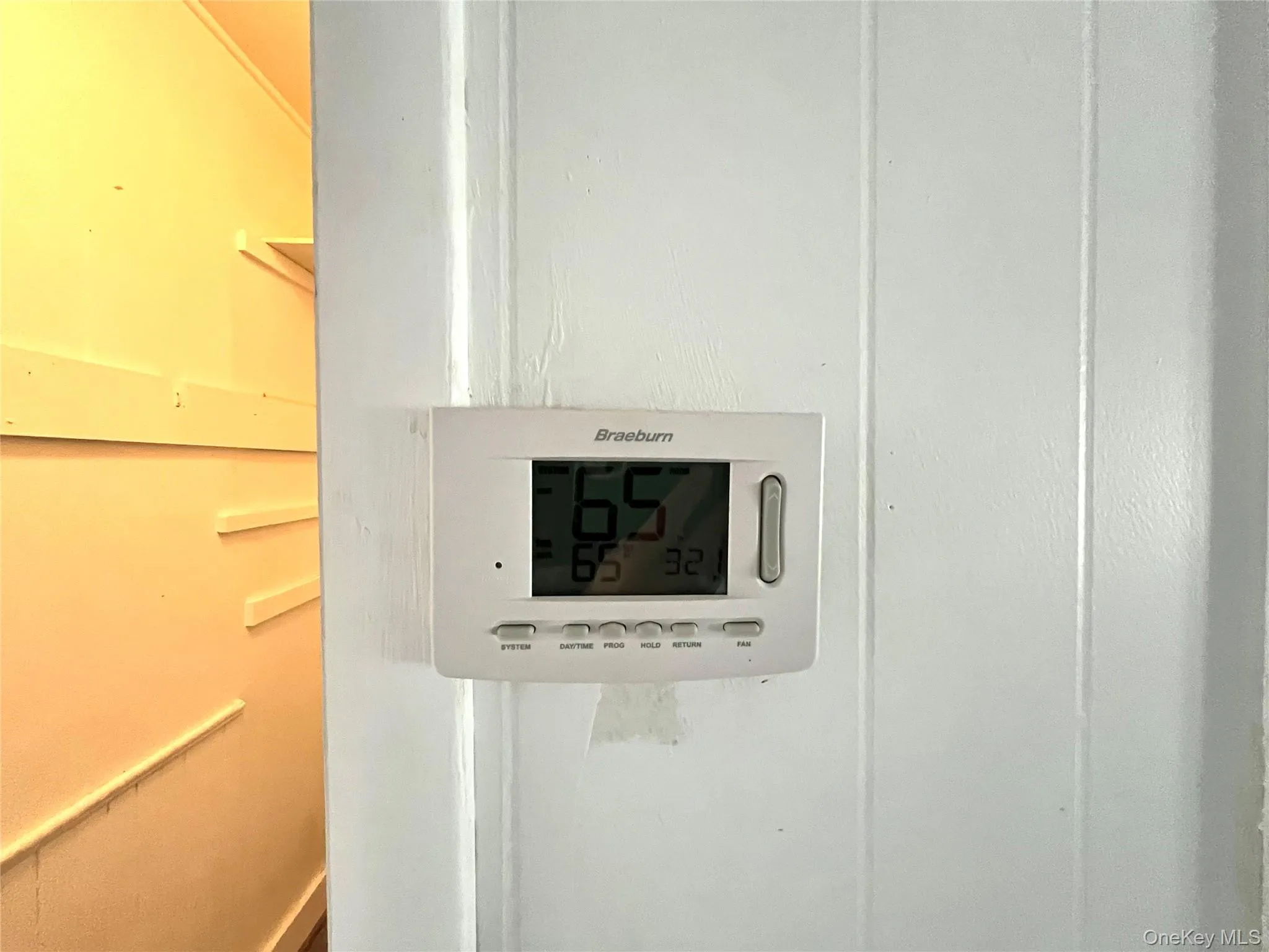 Thermostat - Detailed view next to walk in closet Thermostat - Detailed view next to walk in closet