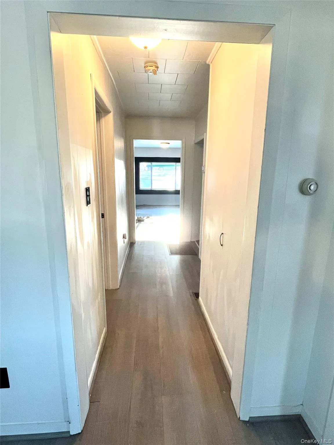 Hallway Corridor featuring dark wood finished floors and baseboards Hallway Corridor featuring dark wood finished floors and baseboards