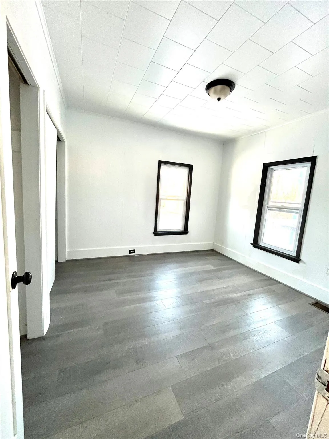 Bedroom 2 Empty room with hardwood / wood-style floors and baseboards/ nice closets Bedroom 2 Empty room with hardwood / wood-style floors and baseboards/ nice closets