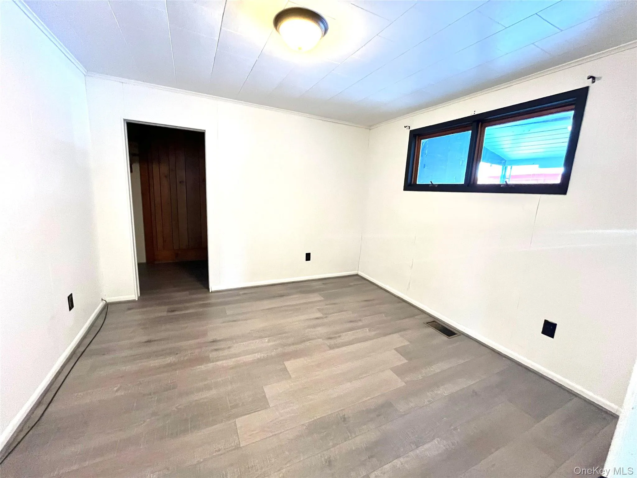 Bedroom 1 Empty room featuring light wood-style flooring and ornamental molding Bedroom 1 Empty room featuring light wood-style flooring and ornamental molding