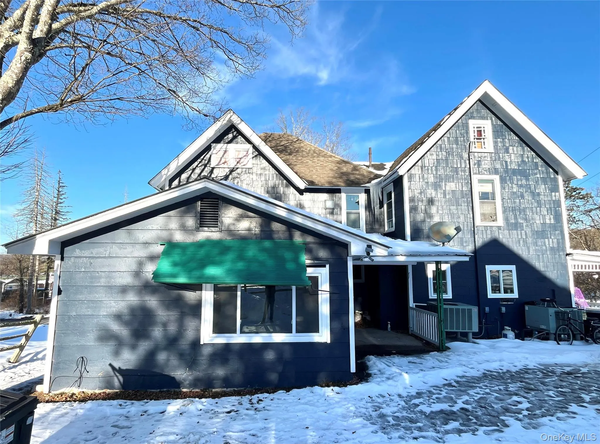 Parking area and View of snow covered back of property Parking area and View of snow covered back of property