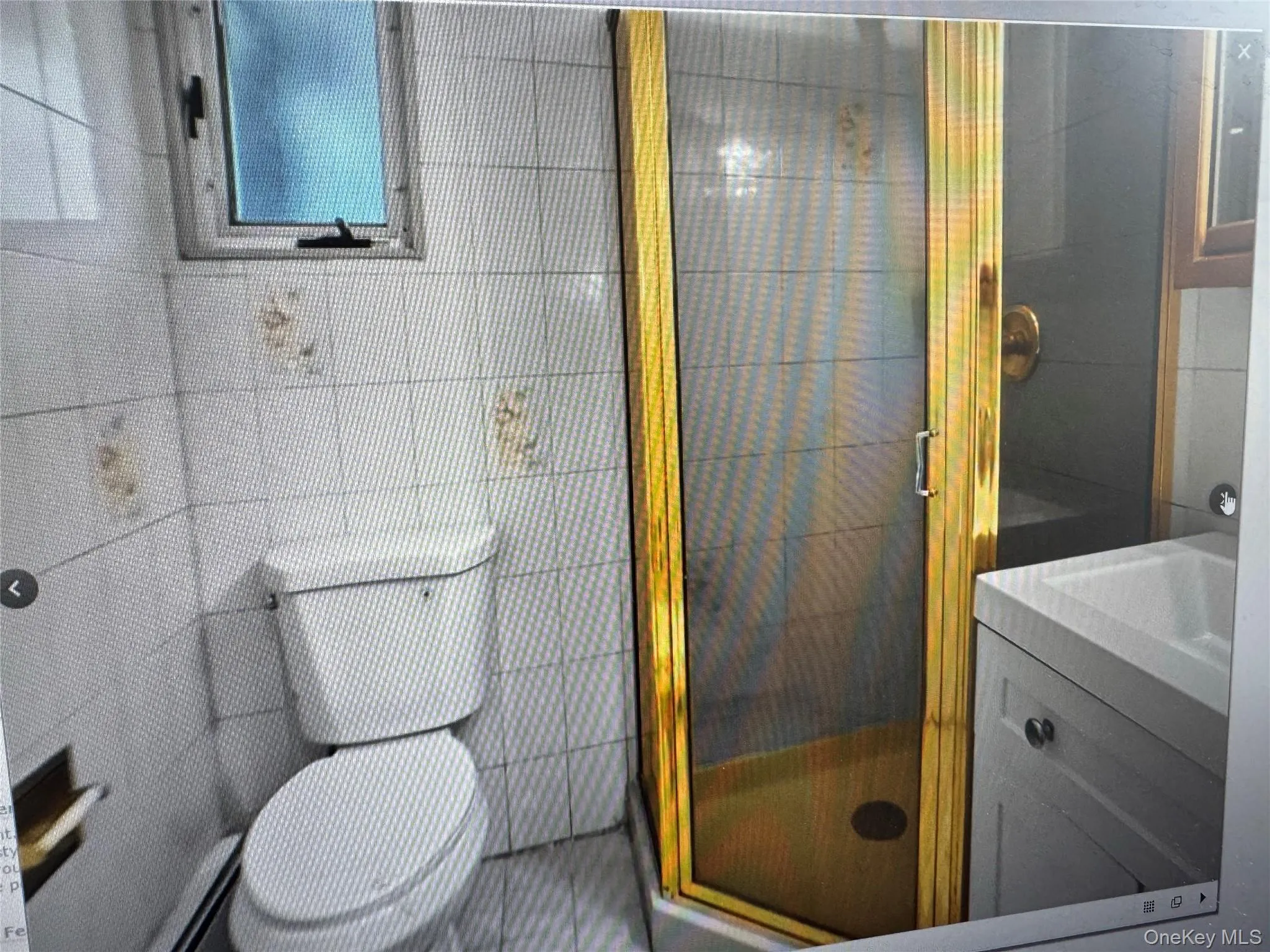 Bathroom featuring a shower stall and vanity Bathroom featuring a shower stall and vanity