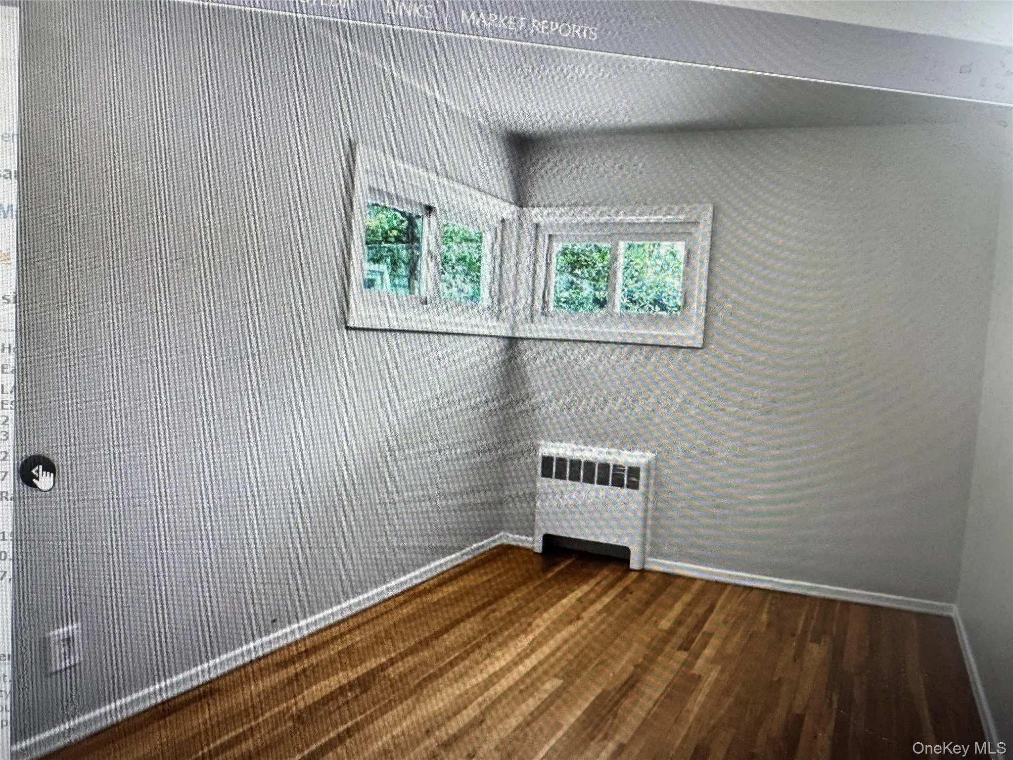 Unfurnished room with radiator heating unit and dark wood-style floors Unfurnished room with radiator heating unit and dark wood-style floors