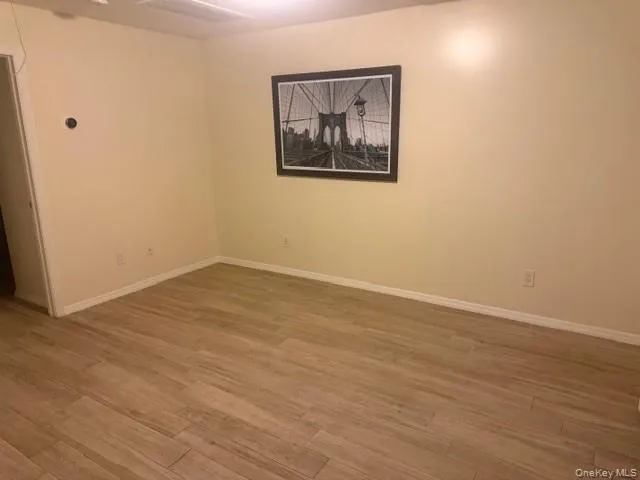 Spare room featuring light wood-style flooring and baseboards Spare room featuring light wood-style flooring and baseboards