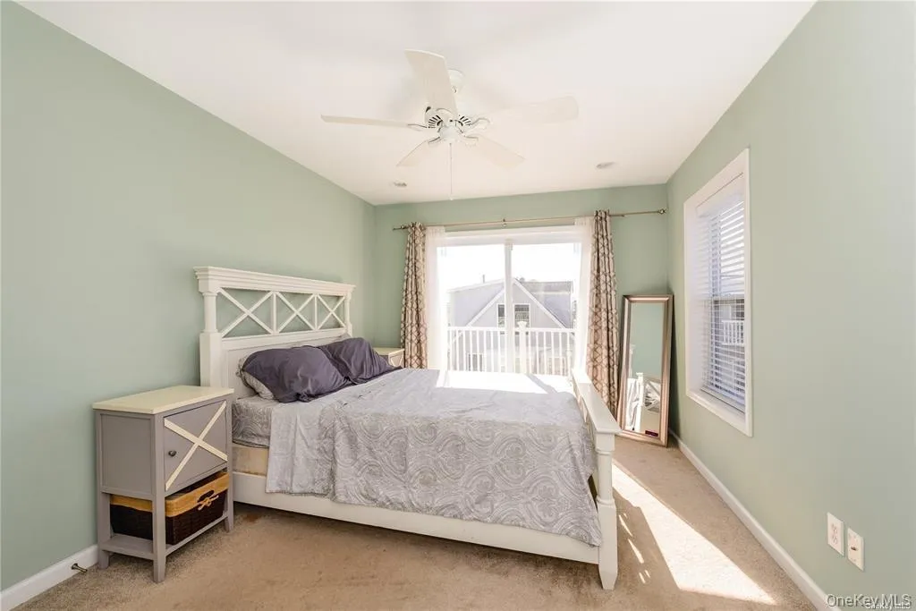 Carpeted bedroom with baseboards and ceiling fan Carpeted bedroom with baseboards and ceiling fan