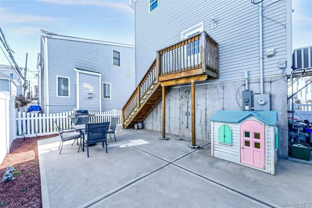 View of patio / terrace with stairway and outdoor dining area View of patio / terrace with stairway and outdoor dining area