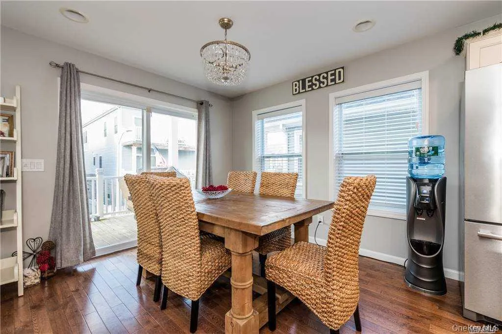 Dining space with dark wood-style flooring, a chandelier, and recessed lighting Dining space with dark wood-style flooring, a chandelier, and recessed lighting