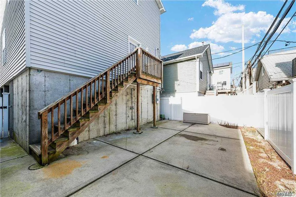 Fenced backyard featuring a patio and stairway Fenced backyard featuring a patio and stairway