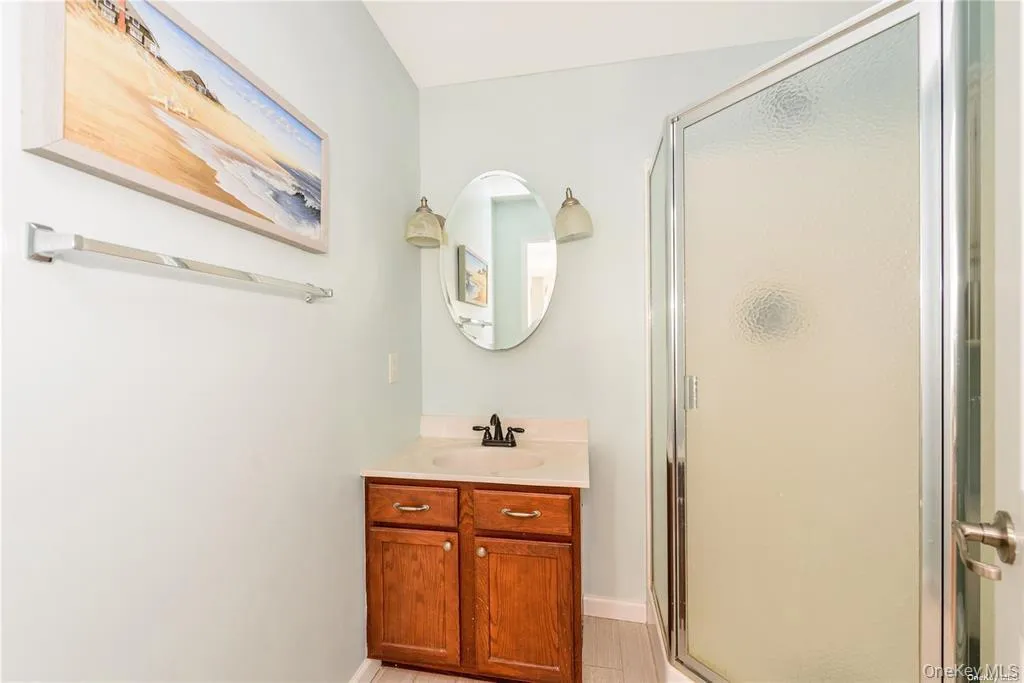 Full bath with a shower stall and vanity Full bath with a shower stall and vanity