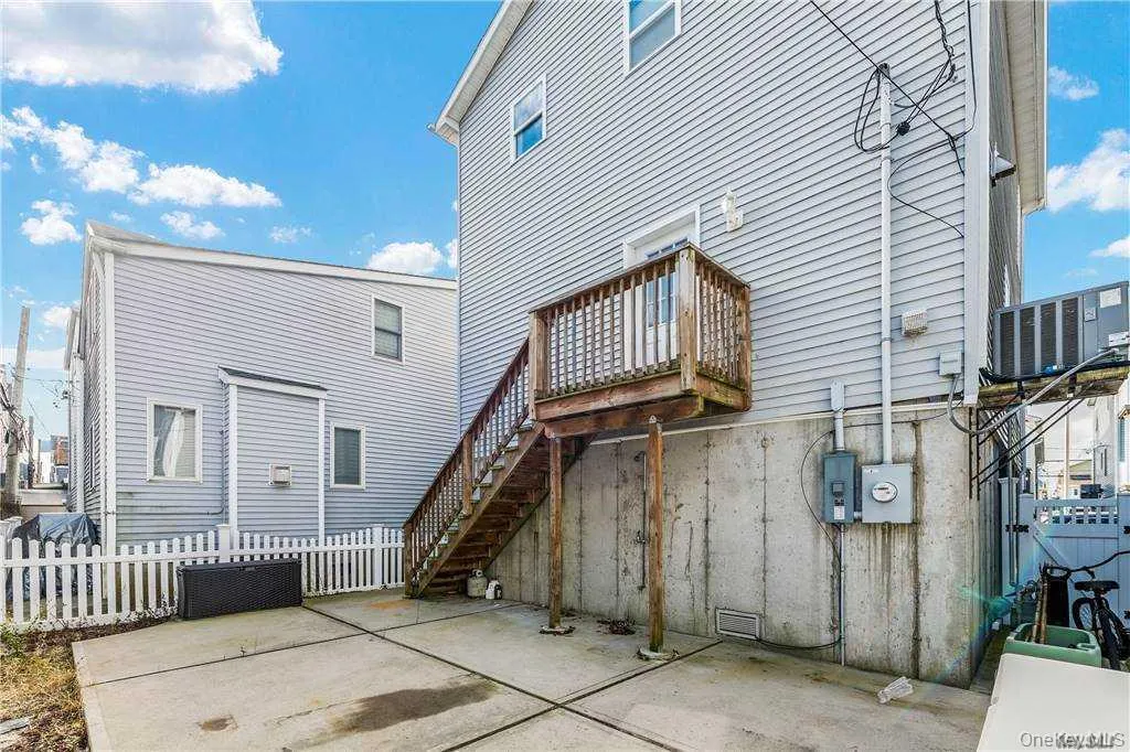 Rear view of property featuring a patio area and stairway Rear view of property featuring a patio area and stairway