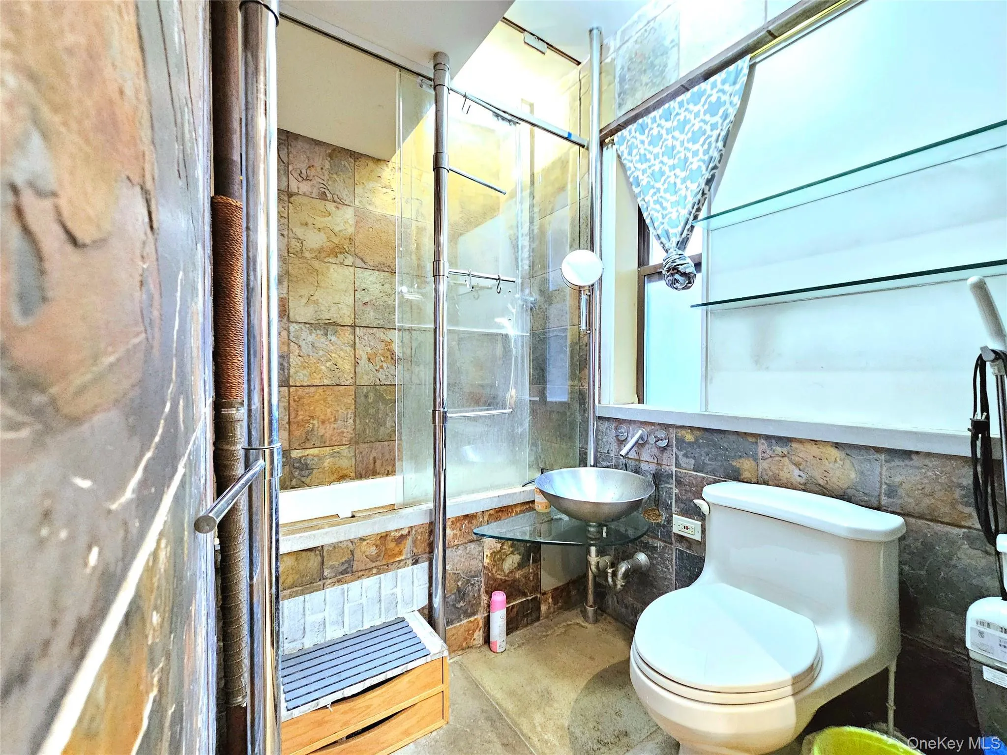 Bathroom featuring tile walls and tiled shower / bath Bathroom featuring tile walls and tiled shower / bath