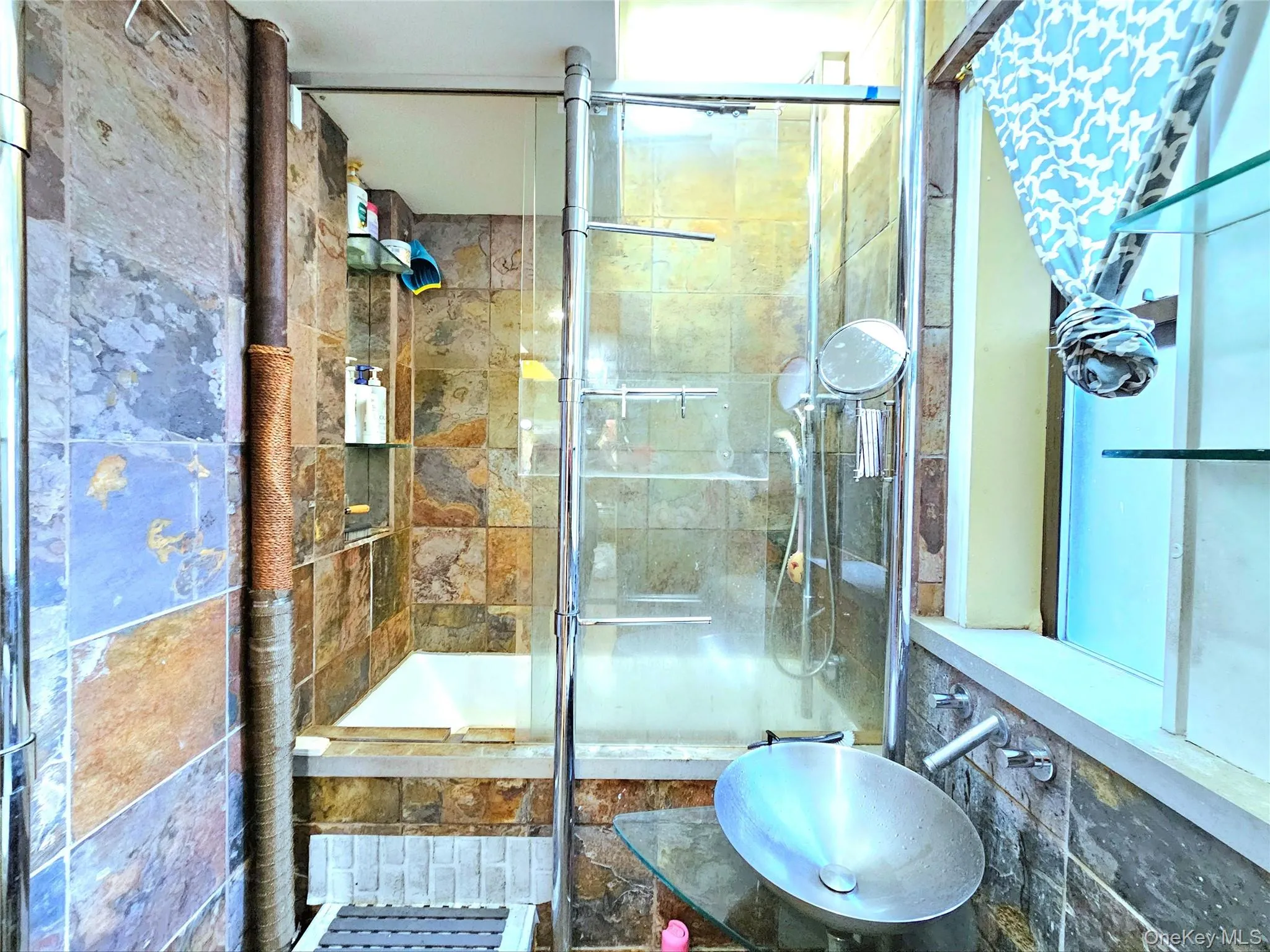 Bathroom with a tile shower and a sink Bathroom with a tile shower and a sink
