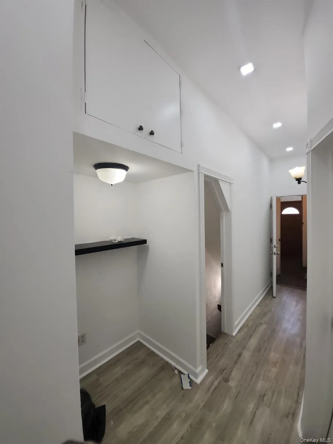 Hallway with light wood-style floors and recessed lighting Hallway with light wood-style floors and recessed lighting