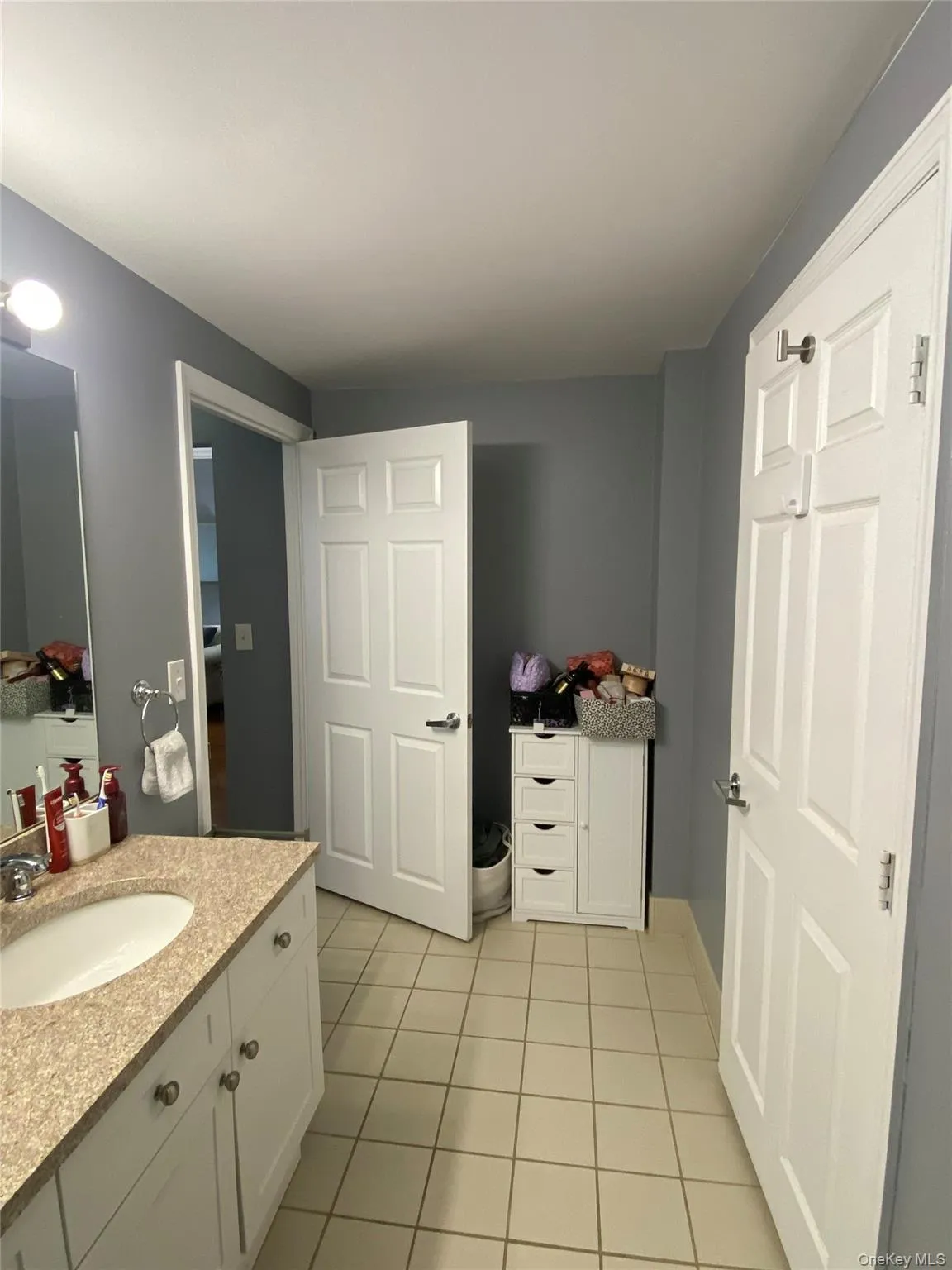 Bathroom with vanity and light tile patterned flooring Bathroom with vanity and light tile patterned flooring