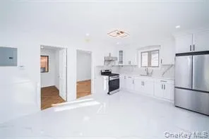 Kitchen with white cabinetry, light countertops, and appliances with stainless steel finishes Kitchen with white cabinetry, light countertops, and appliances with stainless steel finishes