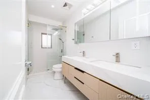 Full bathroom with a stall shower and double vanity Full bathroom with a stall shower and double vanity