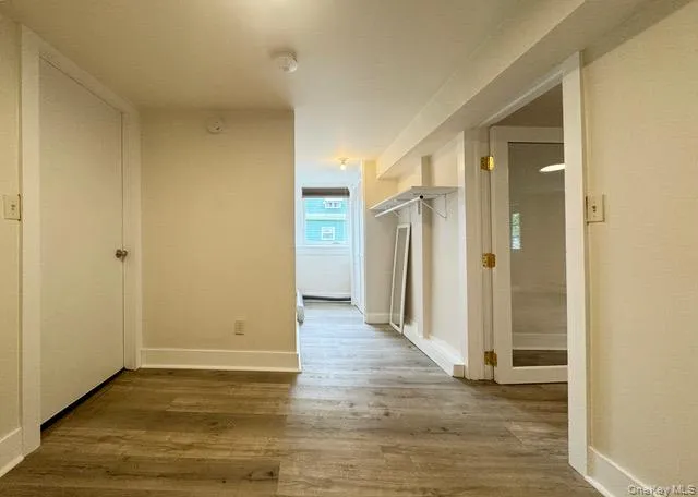 Hall with wood finished floors and baseboards Hall with wood finished floors and baseboards