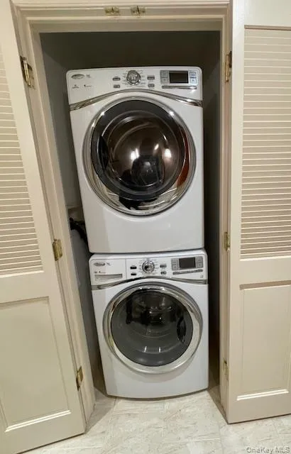 Laundry room featuring stacked washer and clothes dryer Laundry room featuring stacked washer and clothes dryer