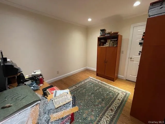 Office area with light wood-type flooring, crown molding, and recessed lighting Office area with light wood-type flooring, crown molding, and recessed lighting