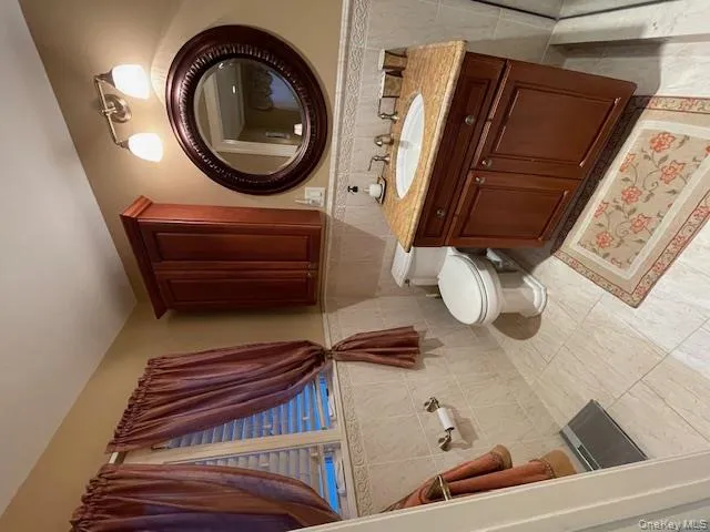 Bathroom with tile walls, a wainscoted wall, and vanity Bathroom with tile walls, a wainscoted wall, and vanity