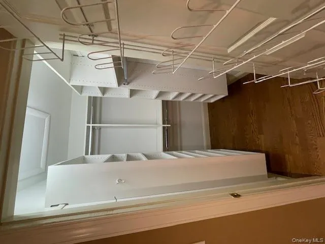 Walk in closet with dark wood-type flooring Walk in closet with dark wood-type flooring