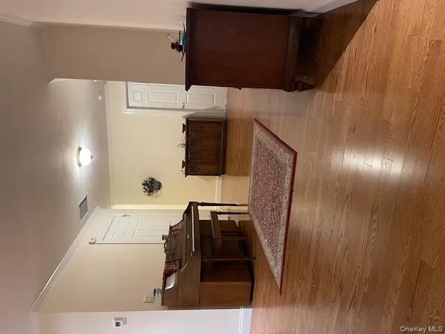 Corridor featuring ornamental molding and light wood finished floors Corridor featuring ornamental molding and light wood finished floors