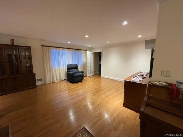 Living area featuring recessed lighting and light wood-style floors Living area featuring recessed lighting and light wood-style floors
