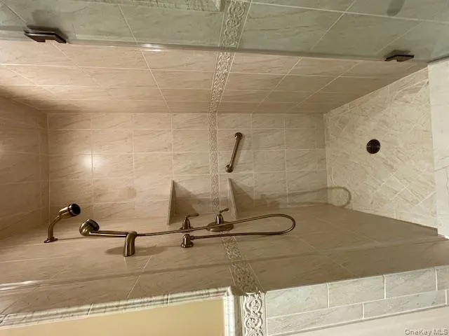Full bath featuring a stall shower Full bath featuring a stall shower